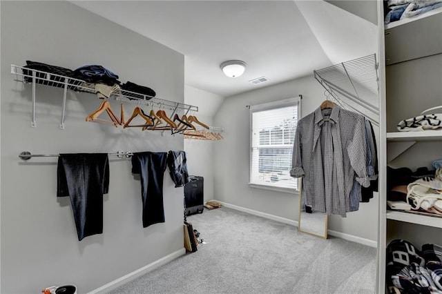 walk in closet featuring carpet and lofted ceiling