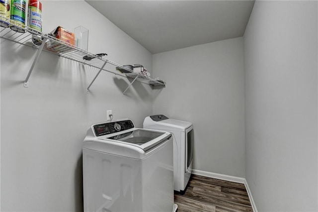 washroom with separate washer and dryer and dark wood-type flooring