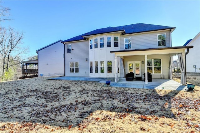 rear view of property featuring a patio area and french doors