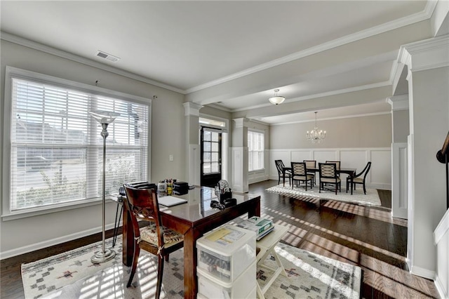 dining space with ornate columns, hardwood / wood-style floors, a healthy amount of sunlight, and ornamental molding