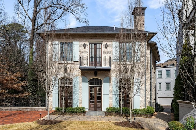 view of front of property with french doors and a balcony