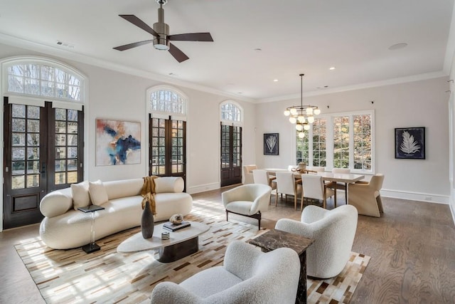 living room featuring crown molding, french doors, and a wealth of natural light