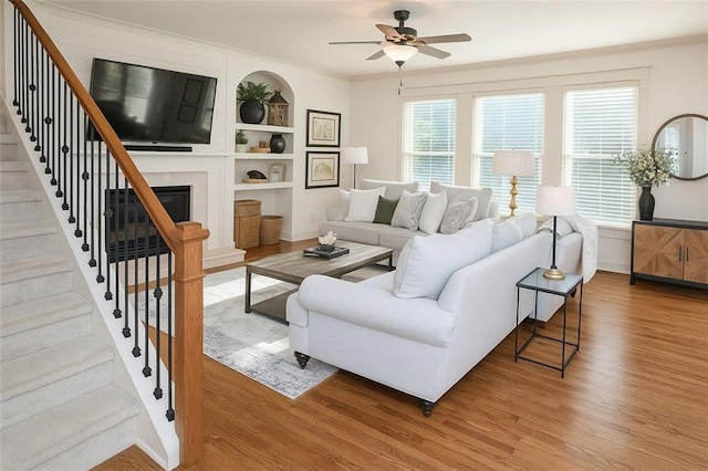 730 Midway Ave, Canton, GA 30114 - living area featuring wood finished floors, built in features, crown molding, ceiling fan, and stairs