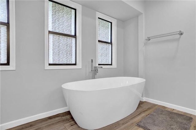 2775 Whippoorwill Cir, Duluth, GA 30097 - bathroom featuring a freestanding bath, wood finished floors, and plenty of natural light