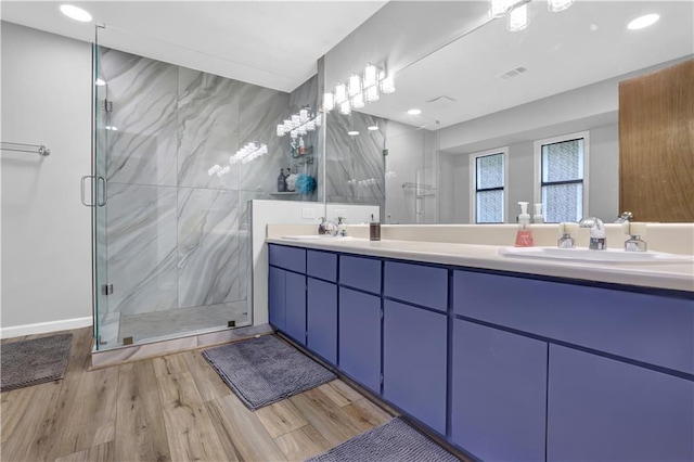 2775 Whippoorwill Cir, Duluth, GA 30097 - bathroom featuring a marble finish shower, double vanity, wood finished floors, and recessed lighting