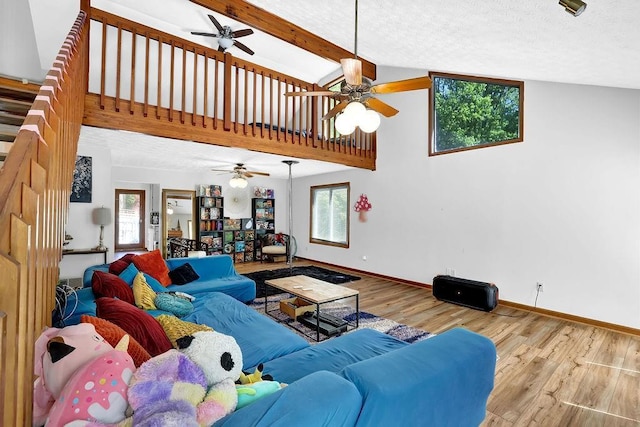 2775 Whippoorwill Cir, Duluth, GA 30097 - living area featuring a ceiling fan, wood finished floors, beam ceiling, and high vaulted ceiling