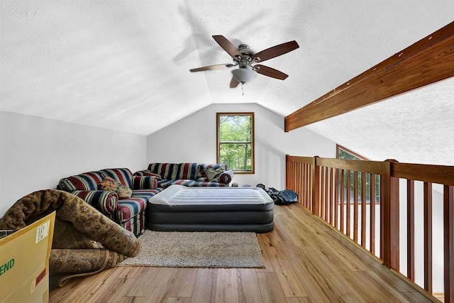 2775 Whippoorwill Cir, Duluth, GA 30097 - bedroom with a textured ceiling, lofted ceiling, wood finished floors, and a ceiling fan