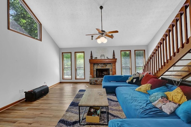 2775 Whippoorwill Cir, Duluth, GA 30097 - living area featuring healthy amount of natural light, a textured ceiling, wood finished floors, ceiling fan, and stairs