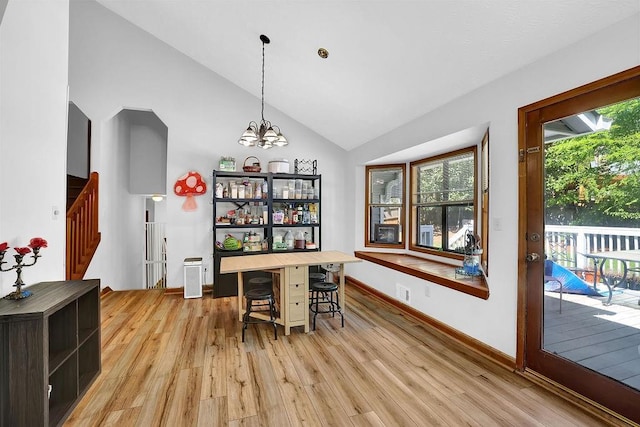 2775 Whippoorwill Cir, Duluth, GA 30097 - dining room with light wood-type flooring, plenty of natural light, stairway, a chandelier, and high vaulted ceiling