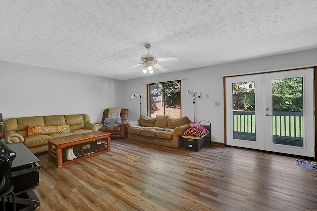 2775 Whippoorwill Cir, Duluth, GA 30097 - living room featuring a textured ceiling, wood finished floors, a ceiling fan, and french doors