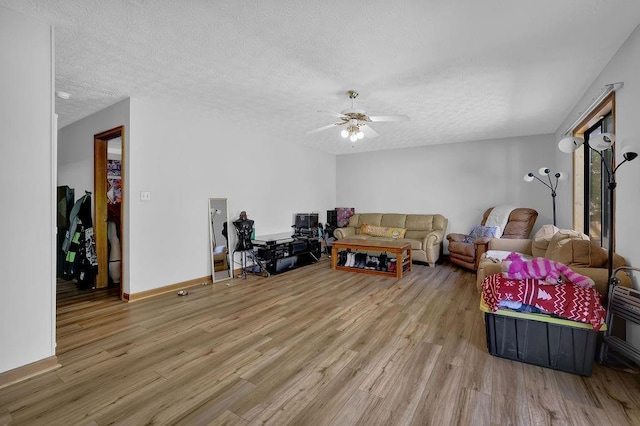 2775 Whippoorwill Cir, Duluth, GA 30097 - living room featuring wood finished floors, a textured ceiling, and a ceiling fan