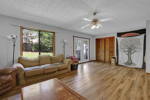 2775 Whippoorwill Cir, Duluth, GA 30097 - living area with light wood-style flooring, ceiling fan, and a textured ceiling