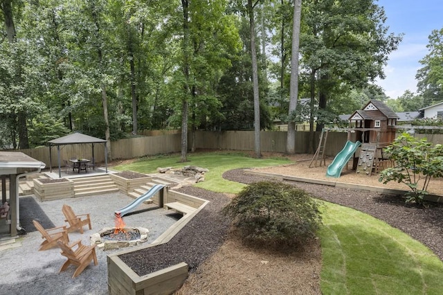3981 Longview Dr, Chamblee, GA 30341 - fenced backyard featuring an outdoor fire pit, a playground, outdoor dining space, and a patio
