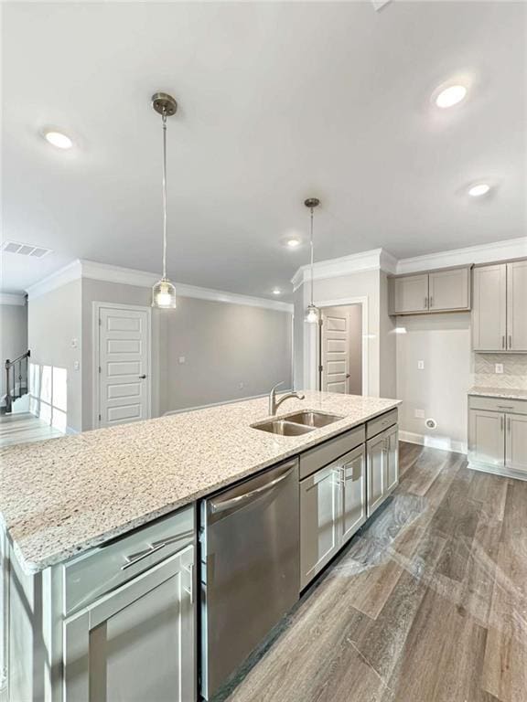 kitchen featuring a sink, light stone countertops, dishwasher, dark wood finished floors, and crown molding