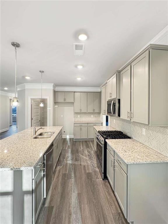 kitchen featuring appliances with stainless steel finishes, crown molding, a sink, and gray cabinetry