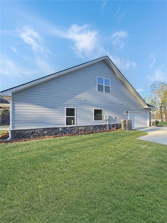 view of side of home featuring a yard and driveway