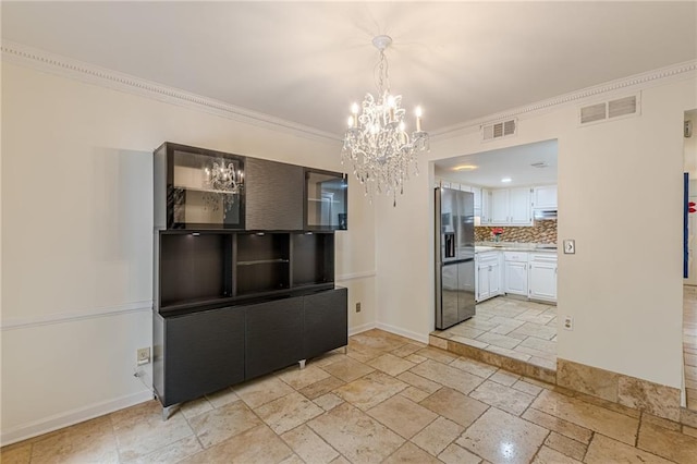 4101 Dunwoody Club Dr Unit 49, Atlanta, GA 30350 - unfurnished dining area with crown molding, visible vents, stone tile floors, and a notable chandelier