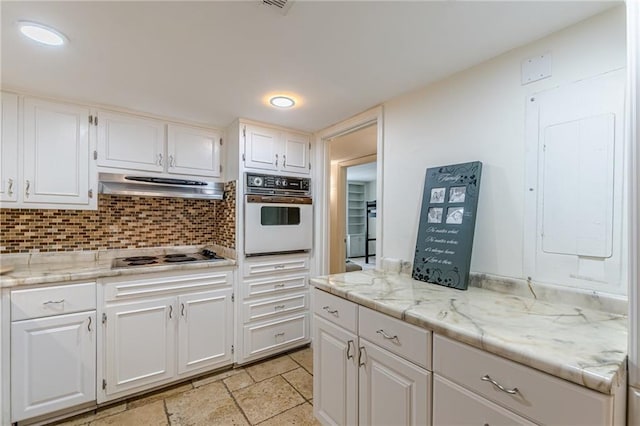 4101 Dunwoody Club Dr Unit 49, Atlanta, GA 30350 - kitchen with oven, extractor fan, white cabinetry, electric stovetop, and tasteful backsplash