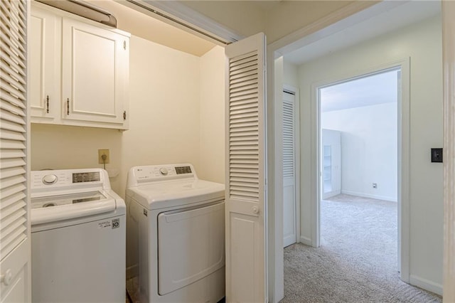 4101 Dunwoody Club Dr Unit 49, Atlanta, GA 30350 - clothes washing area with cabinet space, baseboards, light colored carpet, and washer and dryer