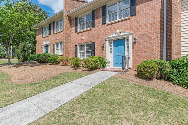 4101 Dunwoody Club Dr Unit 49, Atlanta, GA 30350 - view of front of property with brick siding, a chimney, and a front yard