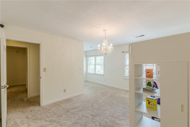 4101 Dunwoody Club Dr Unit 49, Atlanta, GA 30350 - spare room with baseboards, a notable chandelier, light carpet, and visible vents
