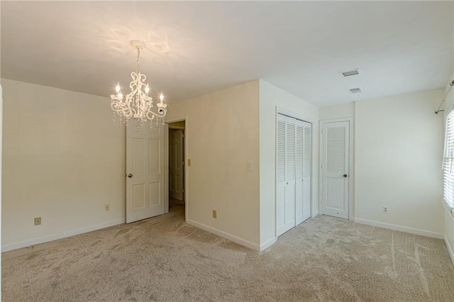 4101 Dunwoody Club Dr Unit 49, Atlanta, GA 30350 - unfurnished bedroom featuring light colored carpet, baseboards, and an inviting chandelier
