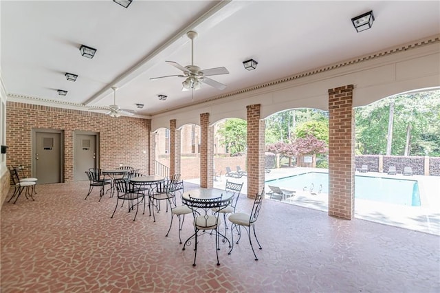 4101 Dunwoody Club Dr Unit 49, Atlanta, GA 30350 - dining room featuring ceiling fan and brick wall