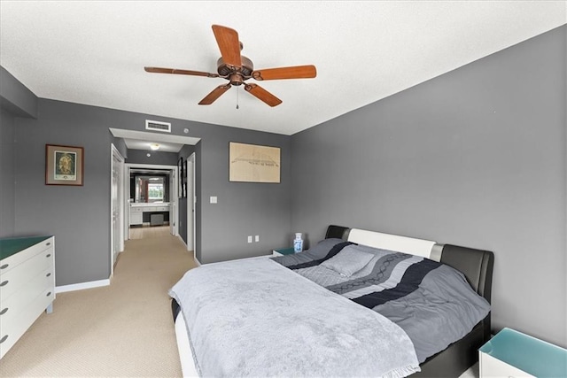 bedroom with light carpet and ceiling fan