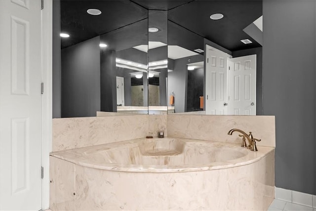 bathroom featuring a tub to relax in and tile patterned flooring