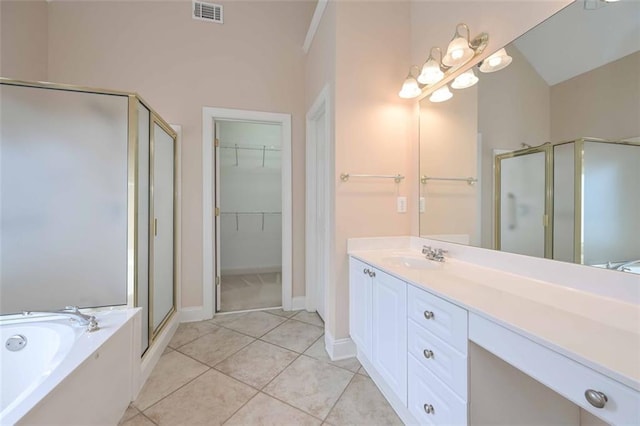 1239 Brentwood Ct, Douglasville, GA 30135 - full bath with a stall shower, vanity, a garden tub, a spacious closet, and tile patterned flooring