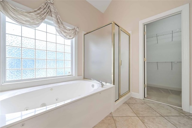 1239 Brentwood Ct, Douglasville, GA 30135 - full bath featuring a stall shower, a tub with jets, a spacious closet, and tile patterned floors