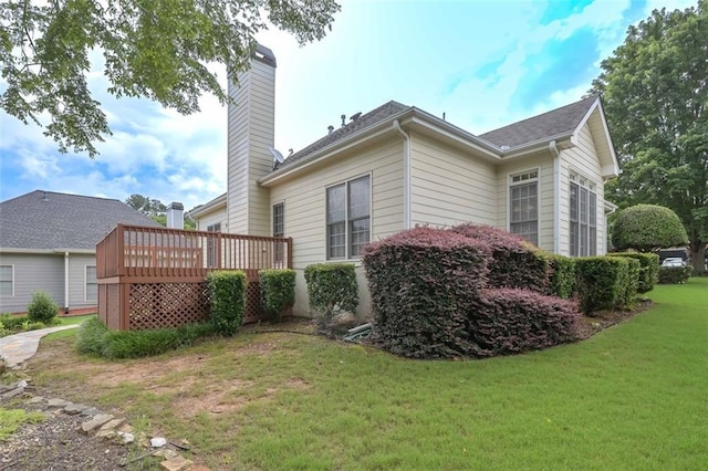 1239 Brentwood Ct, Douglasville, GA 30135 - back of property featuring a wooden deck, a chimney, and a lawn