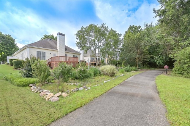 1239 Brentwood Ct, Douglasville, GA 30135 - view of property exterior featuring a chimney, a deck, and a yard
