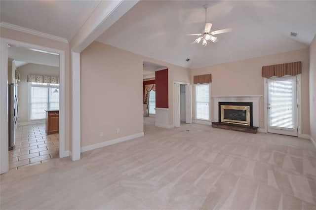 1239 Brentwood Ct, Douglasville, GA 30135 - unfurnished living room featuring light colored carpet, ceiling fan, plenty of natural light, a glass covered fireplace, and lofted ceiling
