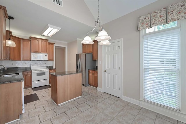 1239 Brentwood Ct, Douglasville, GA 30135 - kitchen with white appliances, a kitchen island, lofted ceiling, decorative backsplash, and hanging light fixtures