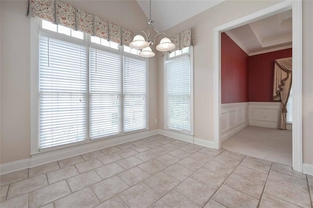 1239 Brentwood Ct, Douglasville, GA 30135 - unfurnished dining area featuring a chandelier, light tile patterned flooring, plenty of natural light, wainscoting, and crown molding