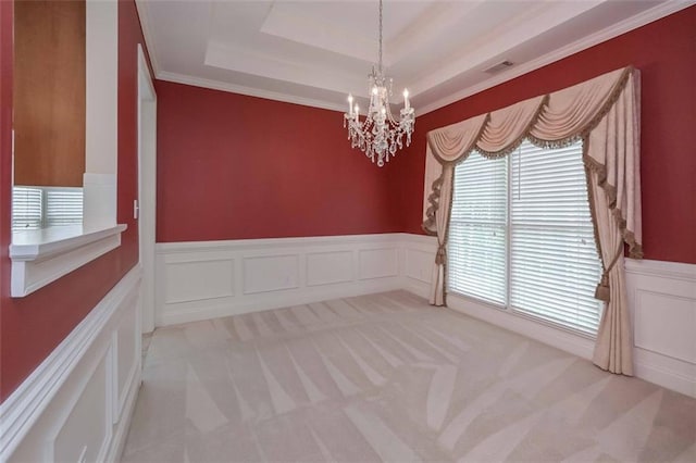 1239 Brentwood Ct, Douglasville, GA 30135 - empty room featuring light colored carpet, a chandelier, a decorative wall, a tray ceiling, and wainscoting
