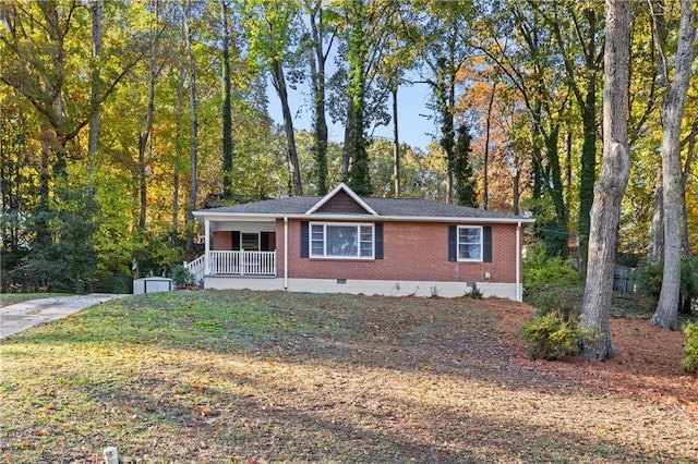 ranch-style house with a porch and a storage unit