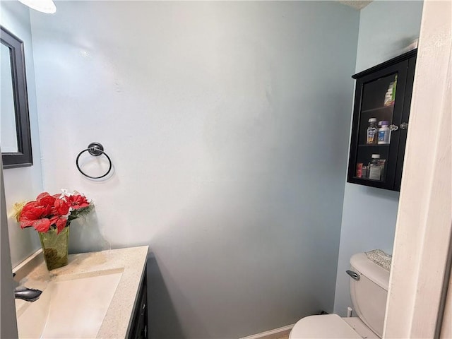 bathroom featuring toilet and vanity