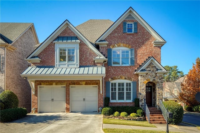 view of front facade featuring a standing seam roof, metal roof, concrete driveway, and brick siding