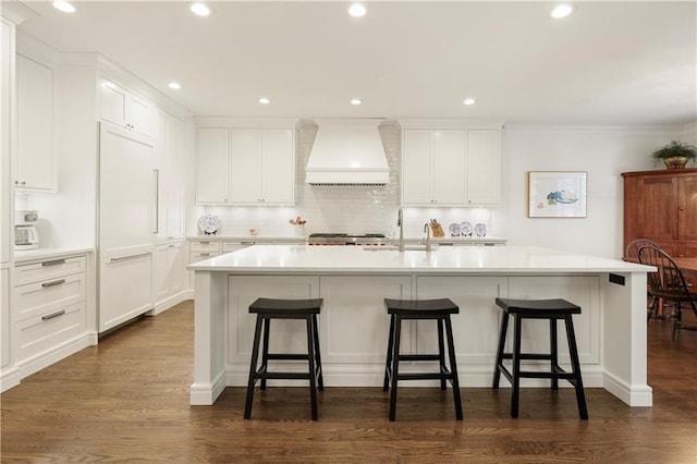 kitchen featuring premium range hood, white cabinets, and dark wood-style flooring