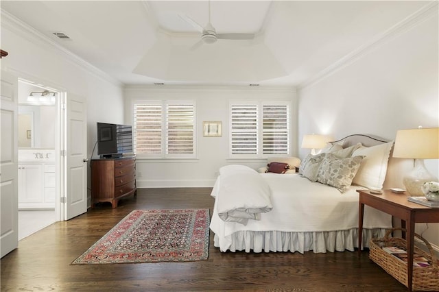 bedroom with baseboards, visible vents, a raised ceiling, dark wood-style floors, and ornamental molding