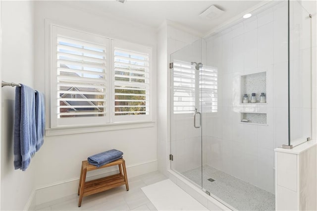 full bath featuring a stall shower and baseboards