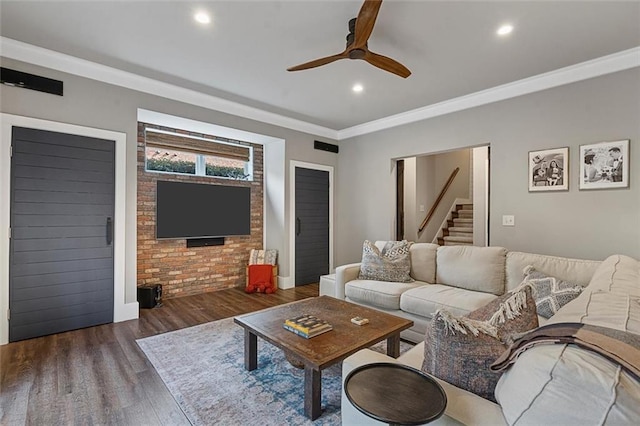 living area featuring recessed lighting, wood finished floors, a ceiling fan, stairway, and crown molding