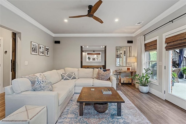 living area featuring crown molding, recessed lighting, visible vents, ceiling fan, and wood finished floors