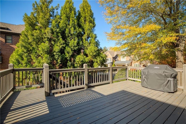 wooden deck featuring a residential view and grilling area