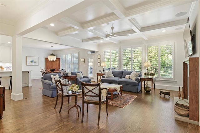 living area featuring ornamental molding, beamed ceiling, coffered ceiling, and wood finished floors