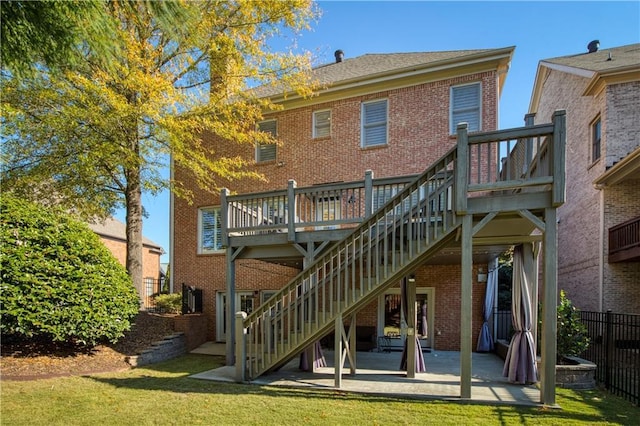 back of house featuring brick siding, a patio, a deck, and stairs