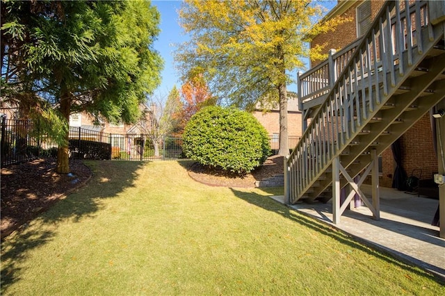 view of yard featuring stairway, a patio area, and fence