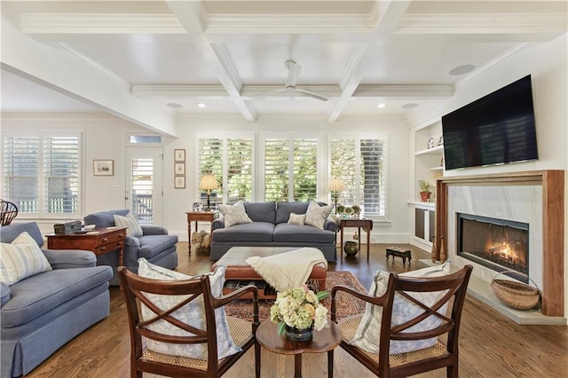 living room with beam ceiling, wood finished floors, and a high end fireplace